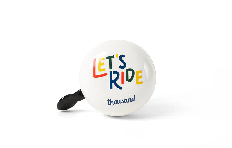 white thousand kids bicycle bell with "let's ride" written on it