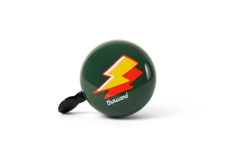 green thousand kids bicycle bell with a yellow and red lightning bolt