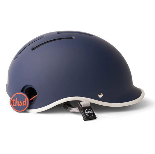 Navy blue Thousand helmet with orange poplock on a white backdrop.