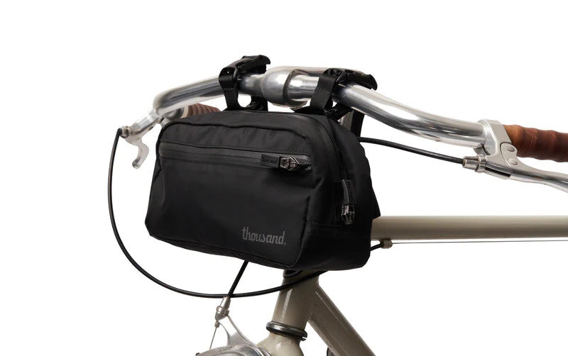 Handlebar bag by Thousand fitted to a bicycle handlebar